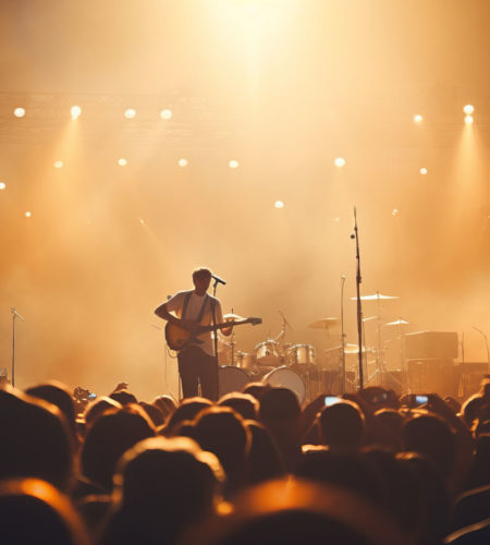 Blurred bokeh lights at music festival with live band and lively crowd dancing and singing along